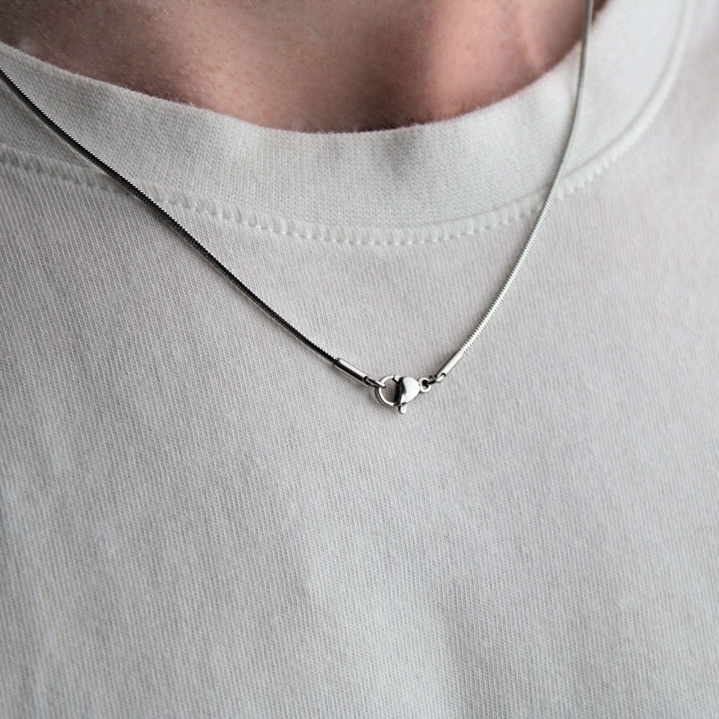 1mm mens snake chain, worn around neck showing lobster clasp..
