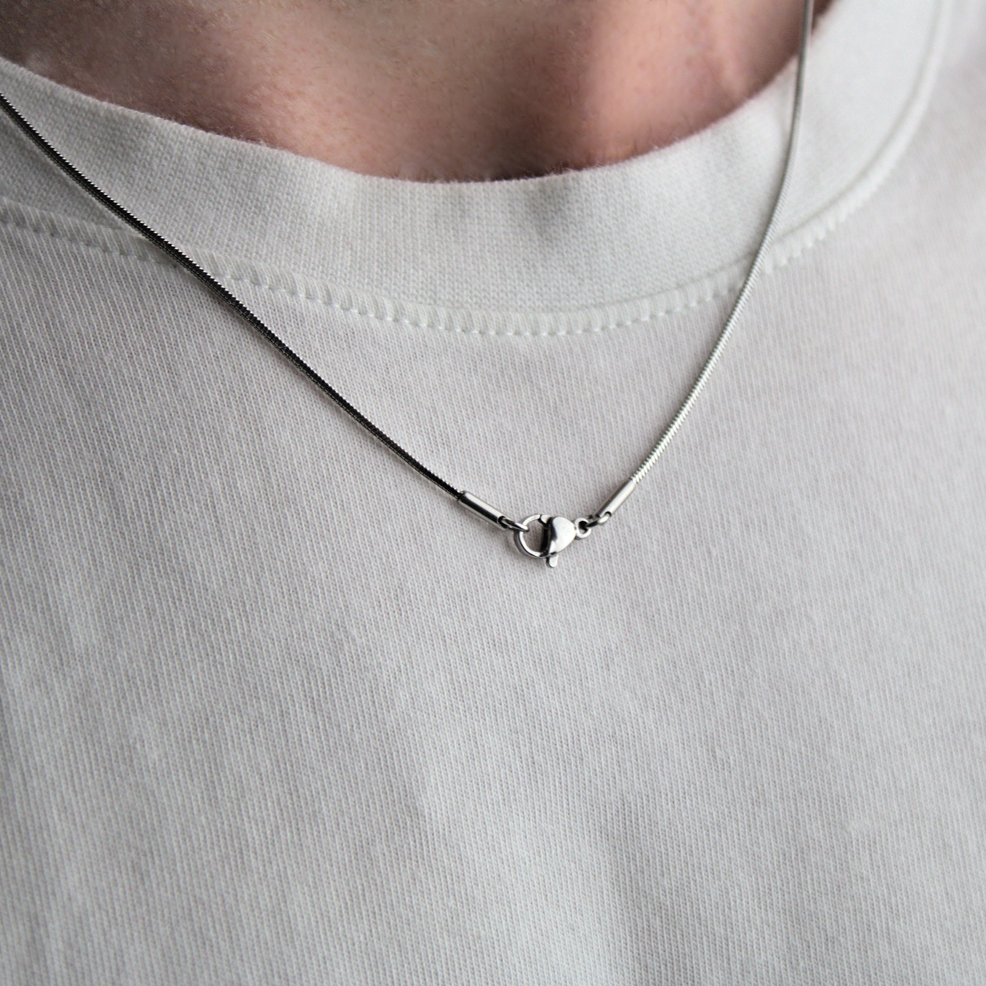 1mm mens snake chain, worn around neck showing lobster clasp..