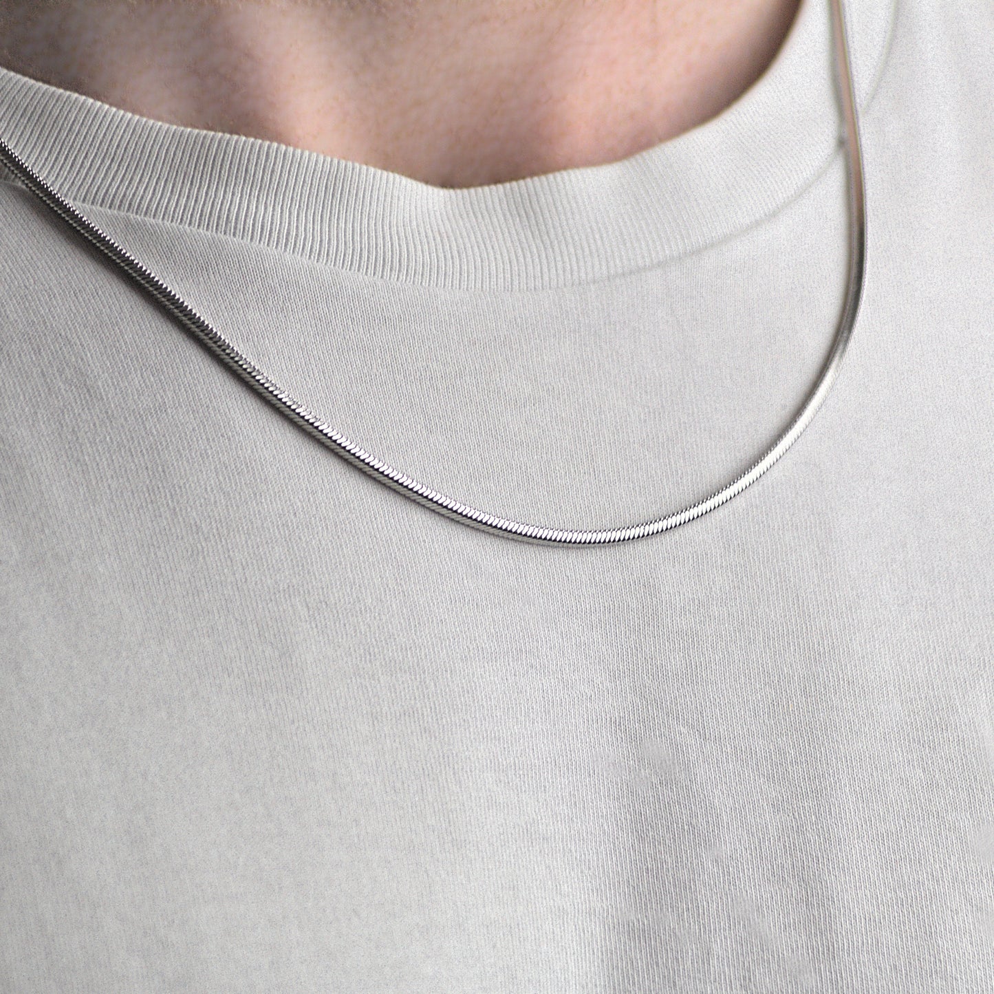 2mm mens snake chain, worn around neck.